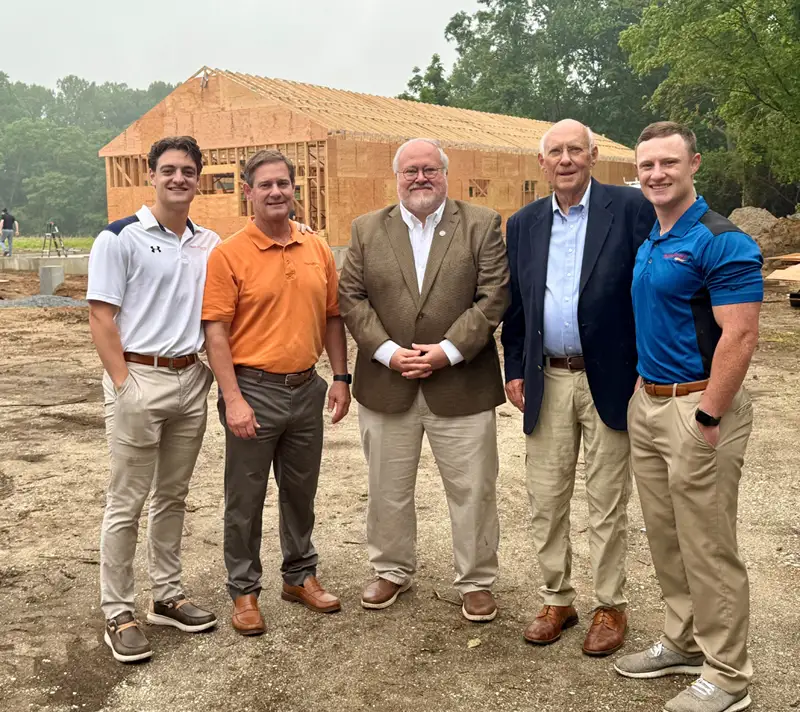 Group of men standing at building construction site