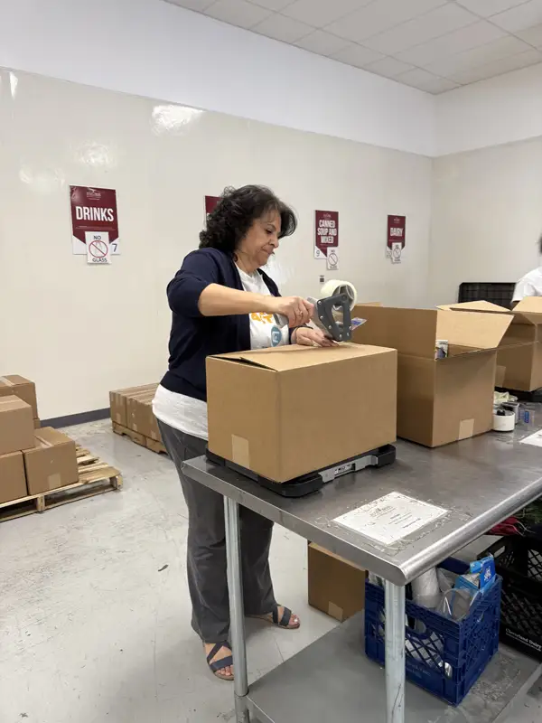 Woman taping a box shut