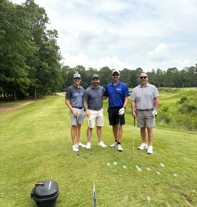 Four bank employees who participated in the golf tournament