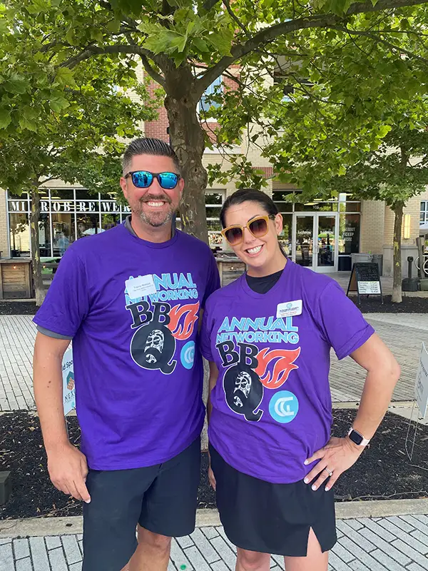 Elmer Bank and Gloucester Chamber representatives pose for picture outside in BBQ shirts.