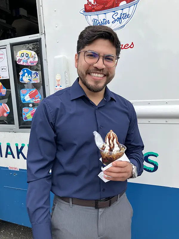 Elmer Bank employee smiling with ice cream in hand.