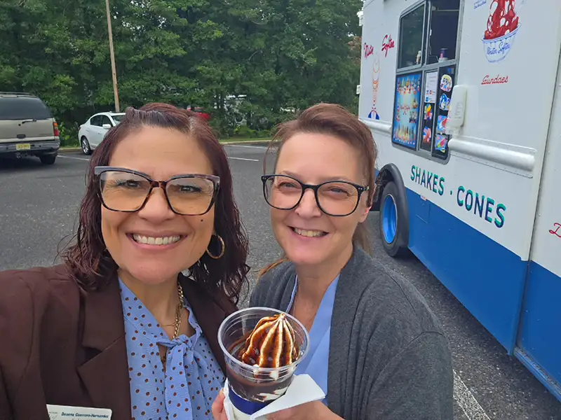 A selfie of two Elmer Bank employees with an ice cream cup.