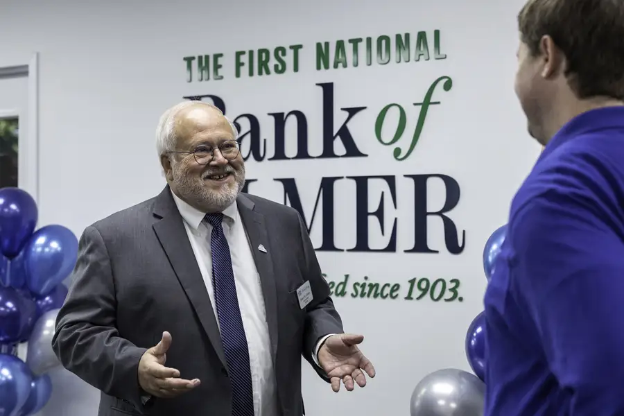 CEO Brian W. Jones standing in front of the Elmer Bank sign