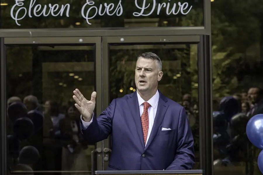 Robert R. Bender speaking in front of doors