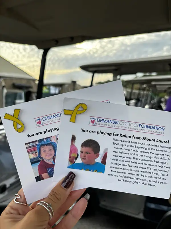Two Emmanuel Cancer Foundation cards with pins attached.