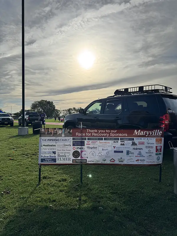 Picture of Sponsor banner for Maryville with sun in the sky and car in background