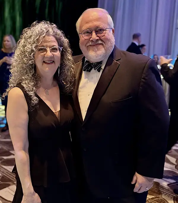 President of Elmer Bank posing next to partner dressed in formal wear